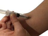 Realistic syringe needle prop with injection effect. The custom built retractable needle features a solid core "needle" that retracts into a spring-loaded cavity hidden inside the barrel of the syringe unit.