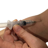 Realistic syringe needle prop with injection effect. The custom built retractable needle features a solid core "needle" that retracts into a spring-loaded cavity hidden inside the barrel of the syringe unit.